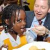 Rudolph Brown/Chief Photographer
Bruce Bowen, President and CEO Scotiabank feeds Natasha Four, at the ScotiaFoundation Breakfast Feeding Programme launch, Scotiabank feed 30 children at the Whitfield All Age School, 20 Whitfield Ave. in Kingston on Wednesday, May 27-2009, Scotia Foundation supports a Breakfast Feeding Programme for 600 Kids in five (5) schools across Jamaica at a cost of $2million.  The schools include Bamboo Primary and Junior High, St. Ann, Holy Family Primary and Infant School, Kingston,  Whitfield All Age School, Kingston, Drapers All Age School, Portland and Norwich Primary, Portland.