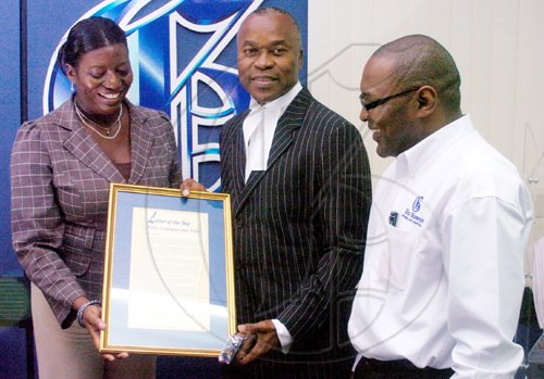 Ricardo Makyn/Staff Photographer.
The Gleaner's Managing Editor Jenni Campbell hands attorney-at-law Bert Samuels a plaque for Silver Pen Award winning letter of the day as Gleaner Editor in Chief Garfield Grandison looks on at the newspaper's North Street, central Kingston offices yesterday.