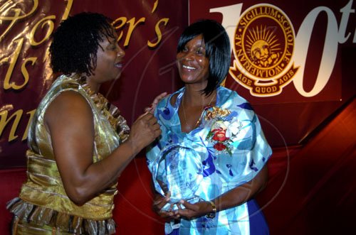 Winston Sill / Freelance Photographer
Maxine Simpson (right), mother of Olympian and Wolmer's old girl Shelly-Ann Fraser, accepts her daughter's award from Dr Verna Reid, president of the Wolmer's Girls' Alumnae. The occasion was the association's Centenary Dinner, Dance and Awards Banquet, held at the Jamaica Pegasus Hotel, New Kingston on Friday night April 24, 2009.