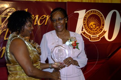 Winston Sill / Freelance Photographer
Dr Verna Reid (left), president of the Wolmer's Girls' Alumnae  presents Olga Geoghagen with her award as one of the eight women honoured at the Centenary Dinner, Dance and Awards Banquet, held at the Jamaica Pegasus Hotel, New Kingston on Friday night April 24, 2009.