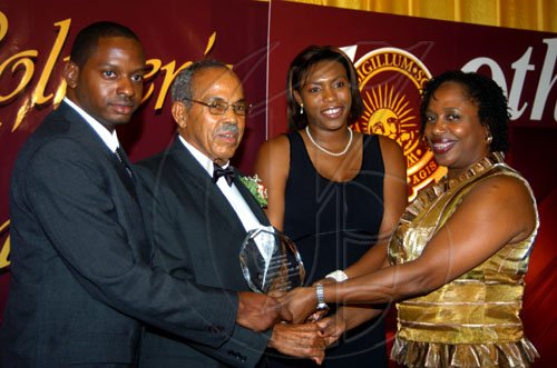 Winston Sill / Freelance Photographer
St Kitts and Nevis High Commissioner Cedric Harper (second left) along with son Douglas and daughter Andrene (second right) accept the posthumous award for Dr Barbara Lyle-Harper from Dr Verna Reid, president of the Wolmer's Girls' Alumnae.
Centenary Dinner, Dance and Awards Banquet, held at the Jamaica Pegasus Hotel, New Kingston on Friday night April 24, 2009.