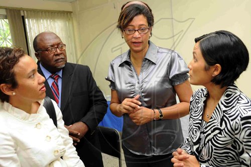 Rudolph Brown/Chief Photographer
Jacqueline Sharp, (left)?President of Insurance Association of Jamaica, IAJ,?in discussion with Orville Johnson, (second left) Executive Director of IAJ, Bridgette Levy, (second right) Insurance Association of Jamaica, IAJ Consultant and?Monique Todd, Chairman of Insurance Association of Jamaica, at the launch of IAJ Mentorship Programme for students who will be participate in the programme at the IAJ Office on Richmond Ave in Kingston on Thursday, July 30-2009.