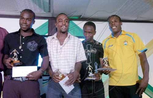 Ricardo Makyn/Staff Photographer.
Top marksmen (from left) Devon Hodges (Rivoli United), Gary McIntosh (Reno), Valentine Gardener (Rivoli United) and Jermaine Anderson (Waterhouse) hold their prizes for the joint leading goalscorer's award, in the all-island Flow Champions Cup, at the presentation ceremony that took place at the Jamaica Football Federation headquarters on Monday. Each of the players scored four goals.