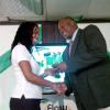 Ricardo Makyn/Staff Photographer.
Boys' Town's Andrew Price (right) receives his award for being the Top Coach from in the all-island Flow Champions Cup from Sharon Roper, marketing manager Flow, at Monday's presentation ceremony at the Jamaica Football Federation headquarters.