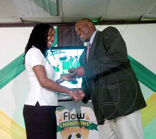 Ricardo Makyn/Staff Photographer.
Boys' Town's Andrew Price (right) receives his award for being the Top Coach from in the all-island Flow Champions Cup from Sharon Roper, marketing manager Flow, at Monday's presentation ceremony at the Jamaica Football Federation headquarters.