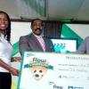 Ricardo Makyn/Staff Photographer.
Sharon Roper, marketing manager, Flow, hands over her company's commitment - the sum total of each goal scored in the Flow Champions Cup KO competition - to Whole Life Ministries' Andre Virtue (right), during the presentation ceremony at the Jamaica Football Federation (JFF) headquarters on Monday. Looking on is JFF president Captain Horace Burell.