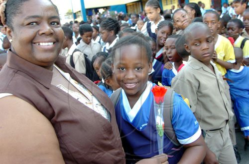 Rudolph Brown/Chief Photographer
Patricia Evan, receive a rose  from her student Crystal Bell on Teachers Day, at Windward Road Primary and Junior High at 141 Windward Road in Kingston on Wednesday May 6-2009.
