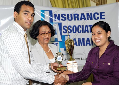 Rudolph Brown/Chief Photographer
Janille Maragh, (right) student of Campion College walk away with all Island Champion Student, Insurance Association of Jamaica, Vivian Rochester Memorial Mathematics competition top trophy after Karen Rochester, (centre) wife of the late Vivian Rochester and son Lance Rochester make the presentation to her at the Hilton Hotel in New Kingston on Friday, June 5-2009.