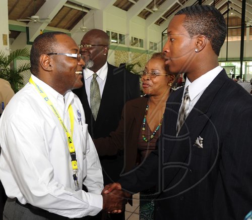 Ricardo Makyn/Staff Photographer.
Left the Gleaner Editor in Chief Garfeild   Grandison greets Glendon Lewis Junior winner of the United Jamaica Alumni Association Essay Competition in America and Who's trip to Jamaica  was sponsored by Jamaiaca National Building Society while looking on is Glendon Lewis Senior with Karin Cooper Manager Cooperate Affairs and  Marketing Department at the  Gleaner  the occasion was the  Governor General's Consultative Youth Breakfast at the Caymanas Golf Club on Friday 15.5.2009.