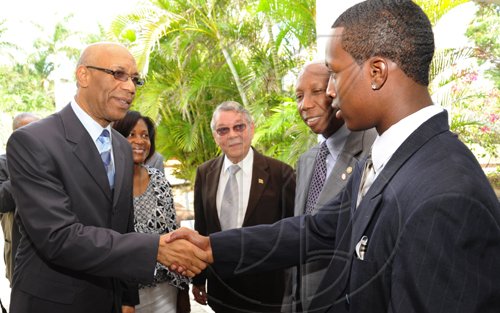 Ricardo Makyn/Staff Photographer.
Left Governor General the Most Hon.Patrick Allen and the Most Hon Mrs Allen greets  Glendon Lewis Junior winner of the United Jamaica Alumni Association Essay Competition in America and Who's trip to Jamaica  was sponsored by Jamaiaca National Building Society while Cutos of Clarendon R James de'Roux and Hugh R Morris National Co-ordinator Governor General achievement Awards Scheme  the occasion was the  Governor General's Consultative Youth Breakfast at the Caymanas Golf Club on Friday 15.5.2009.