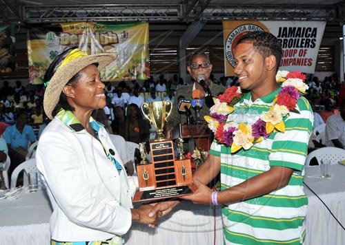 Contributed                                                                              Her Excellency, the Most Hon. Lady Allen, presents the 2010 Junior Champion
Farmer Trophy to 22-year old Rahim Baccas yesterday (August 1), at the
Denbigh Agri- Industrial Show in May Pen, Clarendon. Baccas, who is a
livestock and ground provision farmer, was winning the trophy for the second
time, having captured the title in 2009.