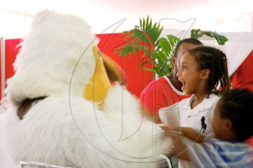 Photo by Laura Redpath
Nishani Clarke, five, and her two-year-old brother, Kishan, play with the University of the West Indies' pelican mascot at the Denbigh Agricultural and Industrial Show in Clarendon on Saturday.