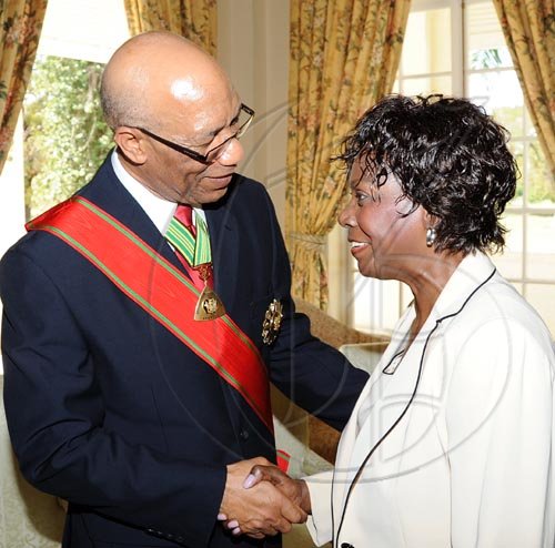 Rudolph Brown/Chief Photographer
Lorna Golding, (right) wife of Prime Minister Bruce Golding in discussion with Governor-General, Dr Patrick Allen,  after the Governor General, invested Desmond Blade with the Order of Jamaica, during the ceremony of investiture and presentation of National Honours and Award at Kings House, St Andrew on Tuesday. May 12-2009