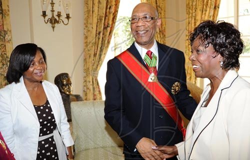 Rudolph Brown/Chief Photographer
Lorna Golding, (right) wife of Prime Minister Bruce Golding in discussion with Governor-General, Dr Patrick Allen, and his wife Patricia Allen, after the Governor General, invested Desmond Blade with the Order of Jamaica, during the ceremony of investiture and presentation of National Honours and Award at Kings House, St Andrew on Tuesday. May 12-2009