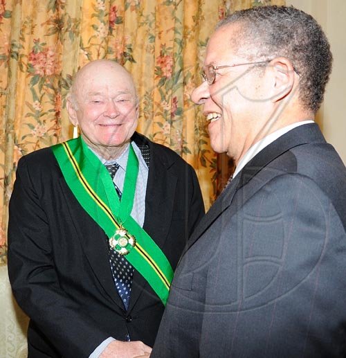 Rudolph Brown/Chief Photographer
Prime Minister Bruce Golding congratulated Desmond Blade after the Governor General Patrick Allen invested the Order of Jamaica on Mr. Blade during a ceremony of investiture and presentation of National Honours and Award at Kings House, St Andrew on Tuesday. May 12-2009