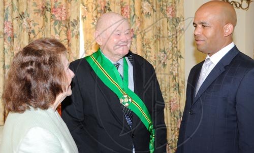 Rudolph Brown/Chief Photographer
Minister of Mining James Robertson chat with Desmond Blade and his wife Peggy after Governor General  invested the Order of Jamaica on Mr. Blade during a ceremony of investiture and presentation of National Honours and Award at Kings House, St Andrew on Tuesday. May 12-2009