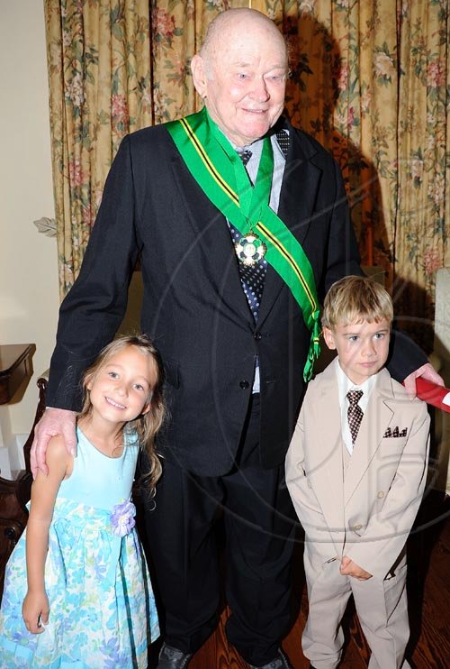 Rudolph Brown/Chief Photographer
Desmond Blade chat with their great grand children after the Governor General Patrick Allen invested the Order of Jamaica on Mr. Blade during a ceremony of investiture and presentation of National Honours and Award at Kings House, St Andrew on Tuesday. May 12-2009