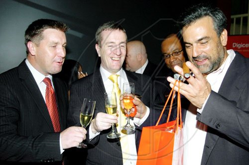 Winston Sill / Freelance Photographer
From left: Digicel's bigwigs Niall Sheehy and Mark Linehan (centre) present the new Blackberry Bold 9700  to Spanish Ambassador Jesus Silva at the phones launch held at Spanish Court Hotel, St. Lucia Avenue, New Kingston on Monday night.

******************************************************************** February 8, 2010.
