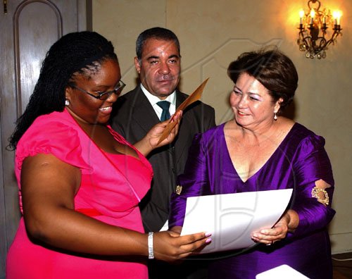 Winston Sill / Freelance Photographer
Monique Long (left) is delighted to receive her first place award for the Professor Juan Bosch Short Story, in honour of the late politician and short story writer. Dominican Republic Ambassador Filomena Navarro (right) presents Long with the award while Avelino Stanley, president of the jury that judged the entries, looks on. The presentation was made at the Gala Awards at King's House, Hope Road on Tuesday June 30, 2009.