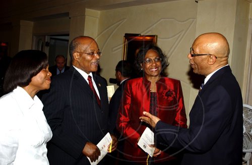 Winston Sill / Freelance Photographer
Governor General Sir Patrick Allen (right) and wife Lady Allen (left) hobnob with his predecessor Sir Kenneth Hall and Lady Hall at the Professor Juan Bosch Short Story Gala Awards, celebrating the  centenary of the late writer/politicians birth, held at King's House Hope Road on Tuesday June 30, 2009.