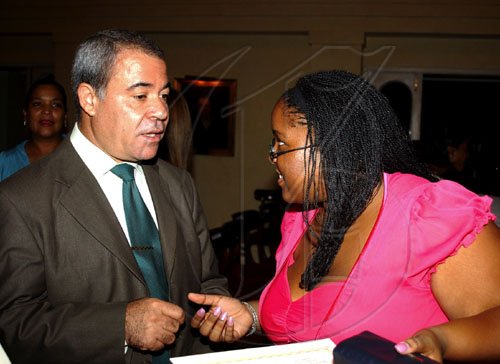 Winston Sill / Freelance Photographer
Avelino Stanley (left) chats with Monique Long, winner of the  Professor Juan Bosch Short Story competition. Stanley was the president of the jury that decided on the winner. The Gala Awards for the competition was held at King's House Hope Road on Tuesday June 30, 2009.