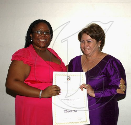 Winston Sill / Freelance Photographer
Monique Long (left) beams as she accepts her first place award from Dominican Republic Ambassador Filomena Navarro for the Professor Juan Bosch Short Story competition. The competition marked the centenary of the late politician/writer, of the Dominican Republic's most famous persons. The Gala Awards were held at King's House Hope Road on Tuesday June 30, 2009.