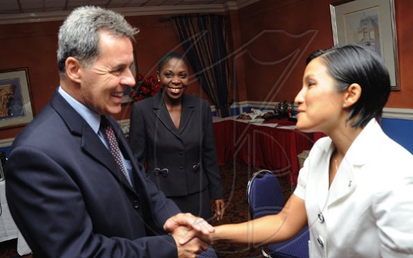 Rudolph Brown/Photographer
Stephen Hallihan, High Commissioner of Canada to Jamaica, greets Monique Todd (right)) of Scotiabank and Joylene Griffiths Irving, (centre) Director, Public and Corporate Affairs  at Scotiabank and CCELD launches Caribbean Canada Emerging Leaders' Dialogue, CCLED Conference 2011 at Courtleigh Hotel in New Kingston on Tuesday, August 17-2010.