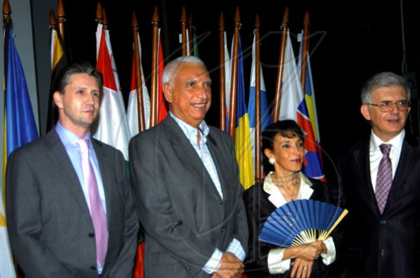 Winston Sill / Freelance Photographer
Attention! European Union (EU) head Ambassador Marco Mazzocchi Alemanni (right) and wife Fiela get the paparazzi treatment with EU official Tom Millar (left) and Colombian Ambassador Ventura Emilio Diaz-Mejia.

Mazzocchi Alemanni host Europe Day Reception, held at Hyperion Avenue, Jacks Hill on Wednesday night May 12, 2010.
