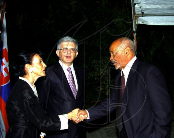 Winston Sill / Freelance Photographer
Still getting to know his diplomatic colleagues, Nicaraguan Ambassador David MacField (right) gets a warm welcome from European Union delegation head Ambassador Marco Mazzocchi Alemanni and wife Fiela.
 Mazzocchi Alemanni host Europe Day Reception, held at Hyperion Avenue, Jacks Hill on Wednesday night May 12, 2010.