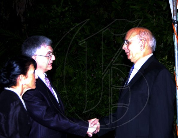 Winston Sill / Freelance Photographer
Ambassador Marco Mazzocchi Alemanni (left) and wife Fiela greet businessman Sameer Younis.

 Mazzocchi Alemanni host Europe Day Reception, held at Hyperion Avenue, Jacks Hill on Wednesday night May 12, 2010.