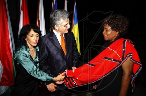 Winston Sill / Freelance Photographer
Head of Delegation of the European Union Ambassador Marco Mazzocchi Alemanni and wife Fiela (left) are intrigued with the garb of South African High Commissioner Faith Radebe.

host Europe Day Reception, held at Hyperion Avenue, Jacks Hill on Wednesday May 13, 2009.
