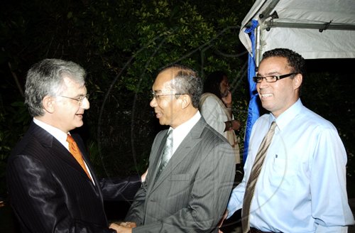 Winston Sill / Freelance Photographer
Head of Delegation of the European Union Ambassador Marco Mazzocchi Alemanni (left), greets Dr Horace Chang (centre), water and housing minister and Daryl Vaz, minister without portfolio responsible for information and telecommunications.
*********************************************************************************
host Europe Day Reception, held at Hyperion Avenue, Jacks Hill on Wednesday May 13, 2009.