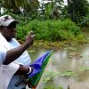 Ricardo Makyn/Staff Photographer.
Residents of Hope Bay look at the Gully that a  Ill Fated bus  ran into  in Hope Bay Portland killing two and also a Five yearold Child is missing.