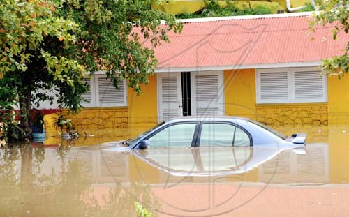 Norman Grindley /Chief Photographer
Flood waters cover this car at the Milk River Hotel and Spa in Clarendon yesterday. The area was flooded after heavy rains on Sunday.