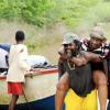 Norman Grindley/Chief Photographer
A guest at the Milk River Hotel and Spa in Clarendon gets a piggy-back ride after being transported by a boat.