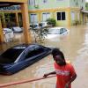 Norman Grindley/Chief Photographer
A man makes his way out of a flooded car park at Milk River Hotel and Spa in Clarendon yesterday.