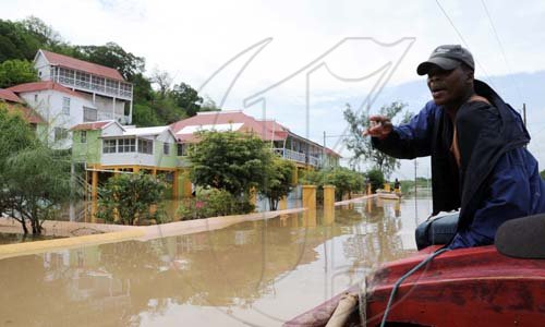 Norman Grindley /Chief Photographer
A man point to the flooded street infront the Milk River hotel and Spa in Clarendon after it was flooded out by heavy rain yesterday.