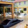 Norman Grindley /Chief Photographer
A woman trudges through the inundated car park at the Milk River Hotel and Spa.

make his way out of a flooded car park at Milk River hotel and Spa in Clarendon yesterday.