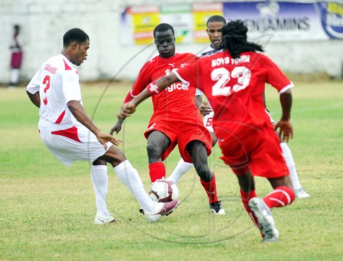 Ricardo Makyn/Staff Photographer.
St Georges Sports Club's Dwayne Holmes (left) and Boys' Town's Marvin Morgan (second left) challenge for the ball, while Boys' Town's Romondo Johnson (right) and St Georges' Ricardo Taylor respond, during the Digicel Premier League football match at Collie Smith Drive yesterday. Boys' Town won 4-2.


Action from the Boys Town vs St Georges match on the openning day of the Digicel Premiere League on Sunday 29.8.2010.