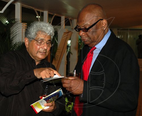 Colin Hamilton/freelance photographer
Arif Ali, author of the book "Jamaica Absolutely" shows Count Prince Miller something on the programme during the
Opening Ceremony of the Inaugural Future Leaders Jamaican Diaspora Conference at the Mona Visitors Lodge on Tuesday August 4, 2009.