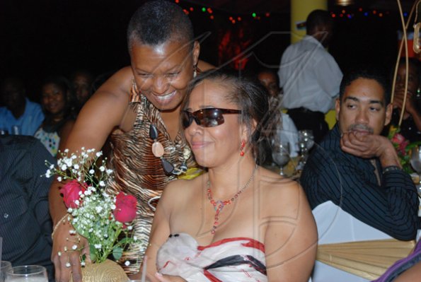 Janet Silvera Photo
 
Birthday girl, Janet Genus (right) had to close her eyes under some dark shades in order to receive her gift from family friend Blanch Burke.

********************************************************** during 50th birthday party at Villa Sonate, Cardiff Hall, Runaway Bay in St. Ann last Saturday night.