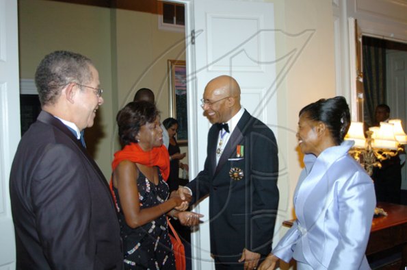 Winston Sill/Freelance Photographer
Governor General Sir Patrick Allen (second right) and Lady Allen (right), greet Prime Minister Bruce Golding and Mrs Golding as they arrive for the  dinner held in honour of the President of Tanzania, Jakaya Mrisho Kikwete at Kings House on Wednesday.

***************************************************************************************** November 25, 2009.