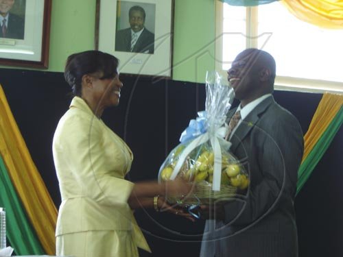 Colin Gager, mayor of Falmouth (right) makes a presentation to Her Excellency the Most Honourable Lady Allen.