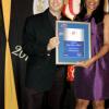 Matthew Deleon accepts his award from Mitsy Burton-Durrant