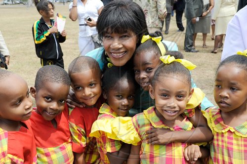 Rudolph Brown/Chief Photographer
Portia Simpson-Miller Opposition Leader hugs the students from St, Theresa's Preparatory School after they perform at the Independence Day Ceremony at Kings House on Thursday, August 6-2009