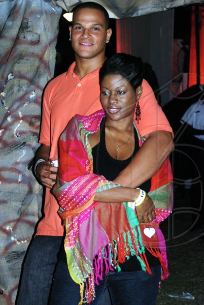 The handsome Marvin Campbell hanging on for dear life on Trinesha McLean at the Tourism Village at the Jamaica Jazz and Blues Festival on Thursday night at the Trelawny Multi-purpose Stadium.