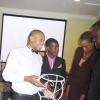 M.A.D.E. scholarship winners Michael Dixon and Andrae Barrett show off their projects for  Opposition Spokesman on Education, Basil Waite, and Courts Research Director Carolyn Thomas at the Courts Award ceremony on August 13, 2009.