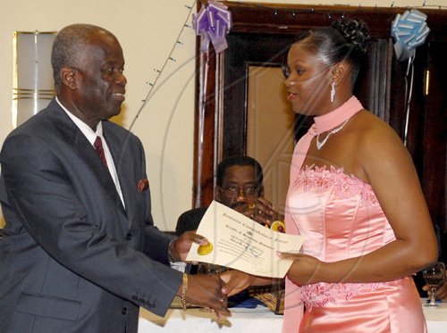 Colin Hamilton/freelance photographer
Cpl. Debby-Ann Ayre receives an award from Dudley Bryan during the Jamaica constabulary Force Awards Dinner at the Pegasus Hotel on Saturday September 5, 2009.