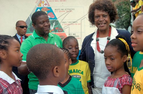 Ricardo Makyn/Staff Photographer.
Principal of the Craighton Primary School Fabian Mahabeer  in the Red Light District in Rural St Andrew with United States Ambassador to Jamaica Pamela Bridgewater with Children from the School at the Schools Jamaica Day on Friday 25.2.2011.