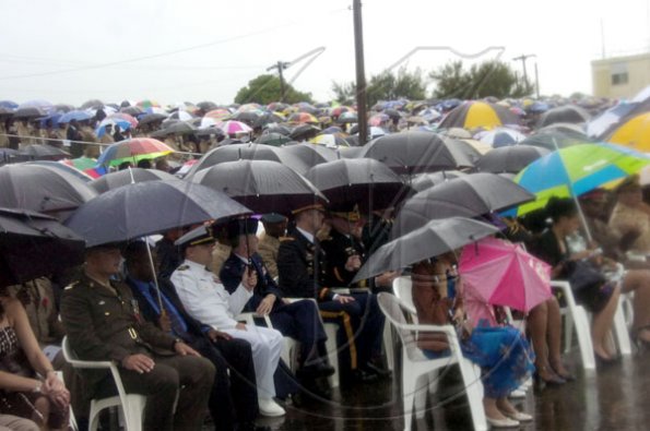 Norman Grindley/Chief Photographer
HERE COMES THE RAIN AGAIN: The umbrellas came out during the Jamaica Defence Force's Change of Command parade on the polo field at Up Park Camp on Saturday.